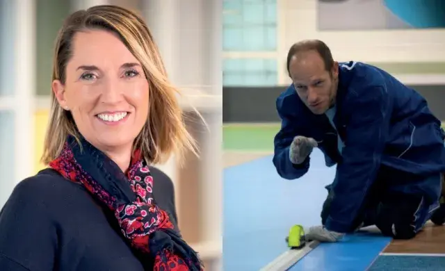 a woman smiling and a man laying flooring